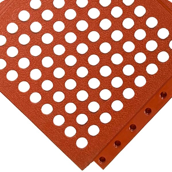 A close-up of the Interlocking Catering Mat reveals its orange-red, textured surface with evenly spaced circular holes in a grid pattern and a bordered row of smaller holes, shown at an angle.