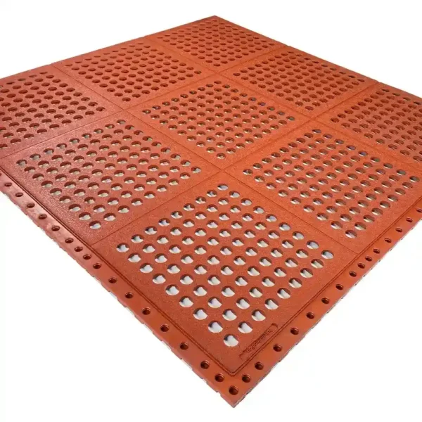 The Interlocking Catering Mat is a red plastic floor mat with circular holes and interlocking edges, displayed at an angle on a white background.