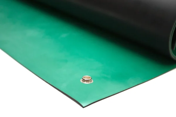 A close-up of the Conductive Rubber Bench Matting in green and black, partially unrolled, with a metal press stud visible on the green surface near the edge.