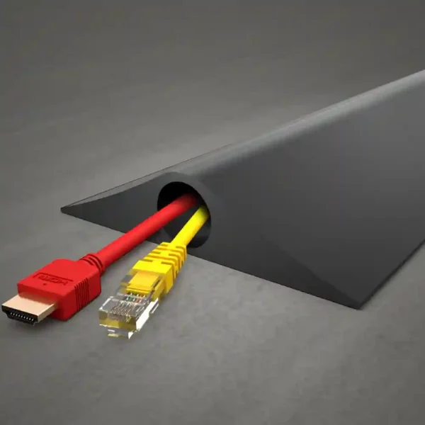 A PVC Cable Protector (HD) in black rests on a grey surface, neatly organising a red HDMI cable and a yellow Ethernet cable as they emerge from one end.
