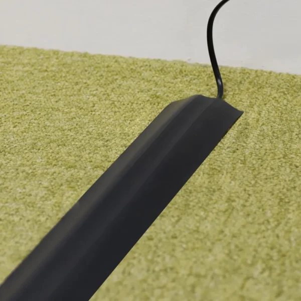 A PVC Cable Protector (GP) lies flat on light green carpet, neatly concealing a black lead as it runs towards a white wall.