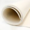 A close-up of the Food Quality Rubber Sheet, shown as a large, thick white sheet rolled into a cylinder with one end on a flat surface. Its smooth texture is visible against a plain white background.