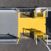 Aerial view of a yellow and grey Anti-Slip Flat Sheet with railings, gates, and grates on asphalt, designed for secure access or walkway use.