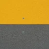 A wall is split horizontally into two equal sections of Anti-Slip Flat Sheet: the top half is textured yellow, the bottom half is textured grey, each with a single visible screw centred in its section.