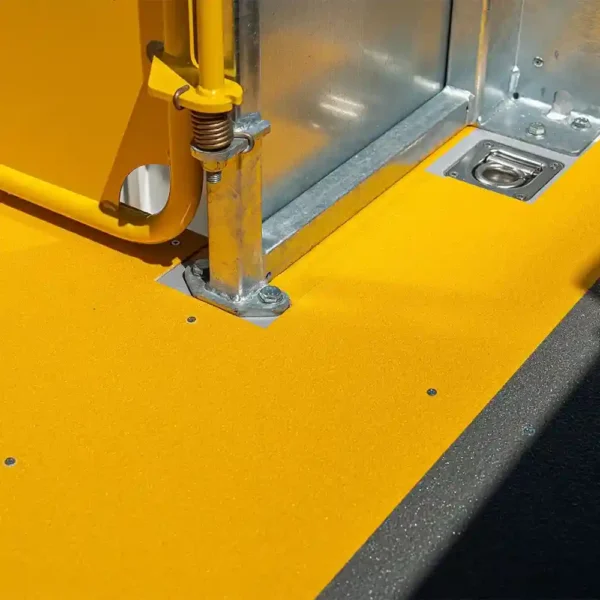 Close-up of the Anti-Slip Flat Sheet in bright yellow, featuring a metal post, spring mechanism, and recessed latch—ideal for industrial use in vehicle interiors or equipment compartments.