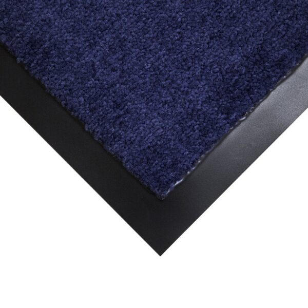 A close-up of the corner of the Plush Entrance Mat shows its dark blue textured surface and black rubber border on a white background.
