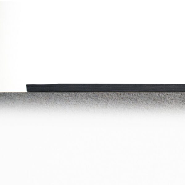 A minimalist scene featuring Electrical Insulation Matting as a grey textured lower area, divided from a white upper background by a black horizontal line for an abstract composition.