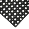 The Fine Ribbed Matting Roll, shown from an angled corner view, is a black rubber mat featuring a textured, grid-like design for slip resistance and drainage. Large and small circular holes are patterned across the surface.